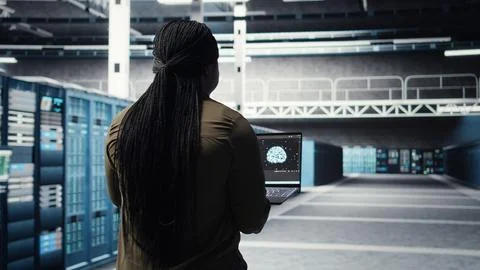 Engineer doing data center automation using AI software tools on laptop Stock Photos
