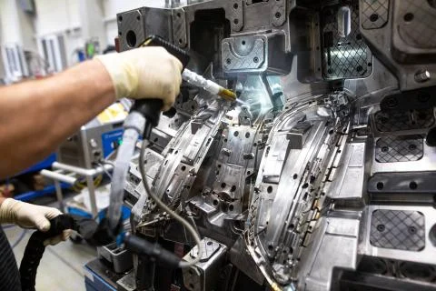 Engineer doing maintenance on the injection mold after production by dry Stock Photos