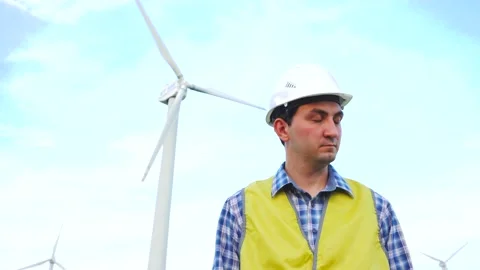 Engineer doing no gesture by shaking his head in front of wind turbines Stock Footage 137968578