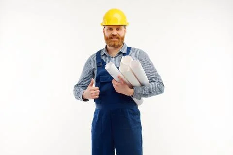 Engineer with drafts in hands is smiling at camera on white background Stock Photos