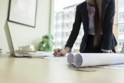 Engineer drawing architecture project on blueprint in office Stock Photos