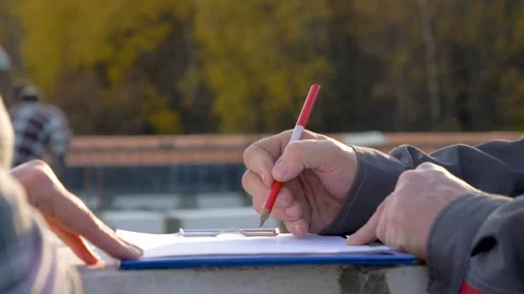 Engineer drawing sketch with red pencil on construction site Stock Footage 316834441