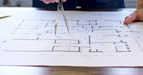 Engineer draws circle using dividers on building floor plan Stock-Footage 243826021