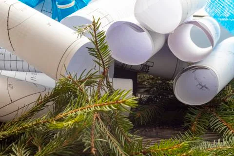 The engineer drew a plan of the house, it is twisted into a roll. They lie on Stock Photos