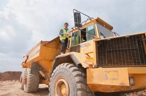 Engineer on dump truck in construction site Stock Photos