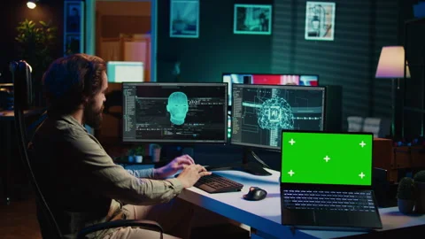 Engineer with EEG headset on merging with AI, green screen laptop Stock Footage 266951866