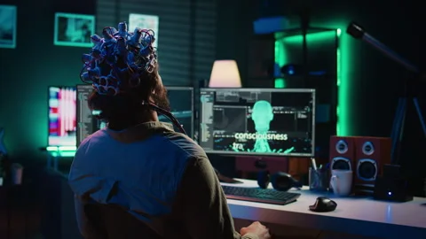 Engineer with EEG headset on merging with artificial intelligence Stock Footage 267045074