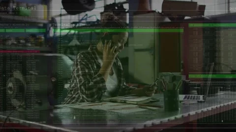 Engineer ending phone call and grabbing phone for reviewing CPU metrics on Stock Footage 319572657
