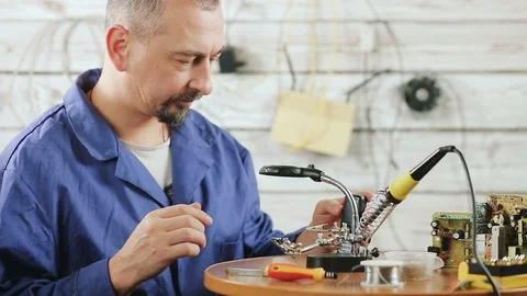The engineer is engaged in repair of the old mobile phone Stock Footage 101022278