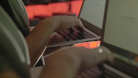 An engineer enters data into a laptop in a mining farm 스톡 동영상 96065213