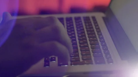 An engineer enters data into a laptop in a mining farm Stockbeeldmateriaal 96065283