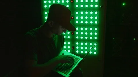 An engineer enters data into a laptop in a mining farm Vidéo 96065731