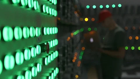 An engineer enters data into a laptop in a mining farm 動画素材 97161710