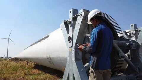 An engineer evaluates wind turbine with a tablet  Stock Footage 121196988