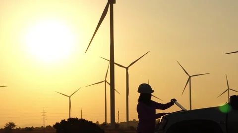 An engineer evaluates wind turbine with a tablet  Stock Footage 121238103