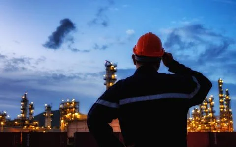 The engineer is facing with large industry background. Stock Photos