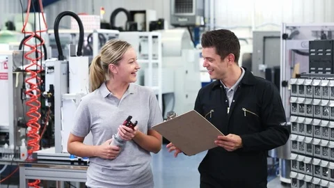 Engineer In Factory Discussing Component With Female Apprentice Video stock 93375505