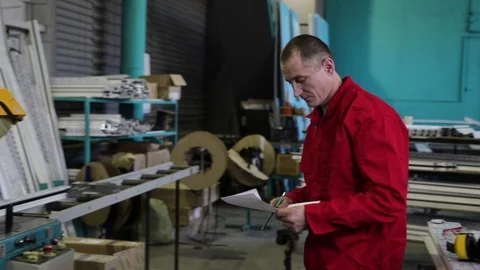 Engineer at the factory. The engineer takes notes. Engineer builder on the const Stock Footage 100879596