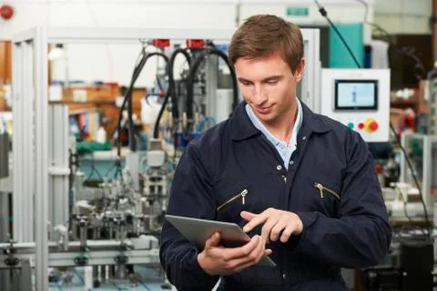 Engineer In Factory Using Digital Tablet Stock Photos
