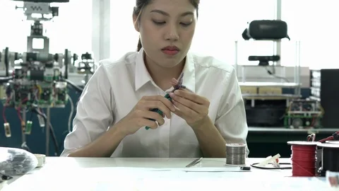 Engineer female design and developing microchip electronic of robot in labs. Stock Footage 112988237