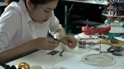 Engineer female design and developing microchip electronic of robot in labs. Stock Footage 112989229