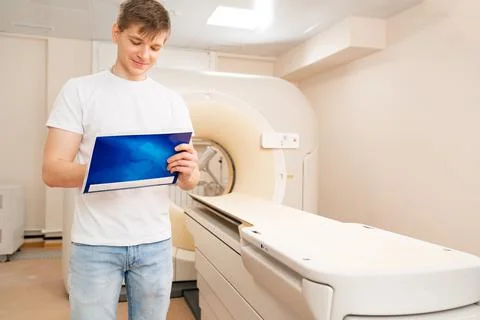Engineer fills after maintenance documents. computer tomograph. Stock Photos
