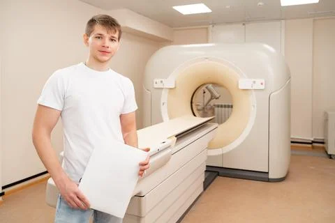 Engineer fills after maintenance documents. computer tomograph. Stock Photos