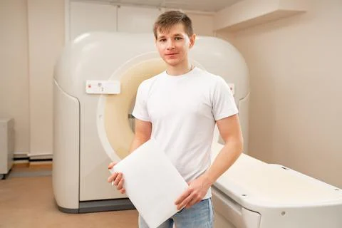 Engineer fills after maintenance documents. computer tomograph. Stock Photos