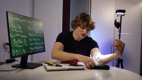 Engineer fine tunes glowing arm implant while coding neural systems in home lab Stock Footage 324443139