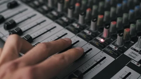 Engineer Fine Tuning Fader on Audio Mixer Board Stock Footage 319040742