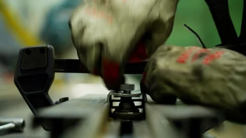 The engineer fixes the part with bolts, tightening them with a special wrench. Stock Footage 314797370