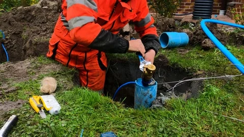 The engineer fixes the parts of the submersible pump together Stock Footage 194588545
