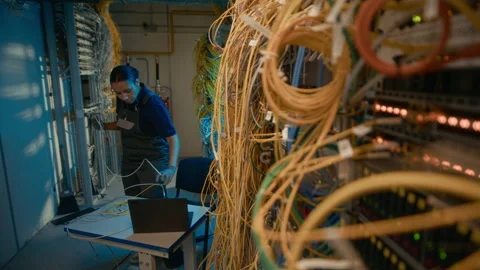 Engineer Fixing and Connecting Cables in Server Room Stockbeeldmateriaal 311311623