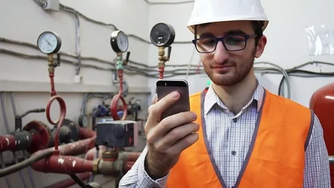 Engineer foreman heating works on location talking on the phone Stock Footage 84794711