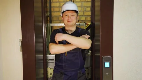 An engineer, foreman, serviceman, senior foreman inspects an elevator shaft Stock Footage 265257955