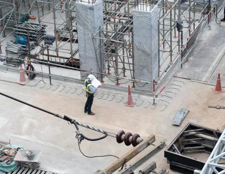 Engineer with full safety set in construction area checking drawing Stock Photos