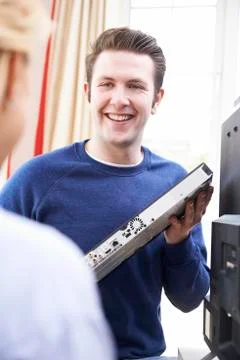 Engineer Giving Advice On Installing Digital TV Equipment Stock Photos