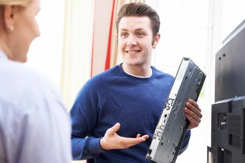 Engineer Giving Advice On Installing Digital TV Equipment Stock Photos