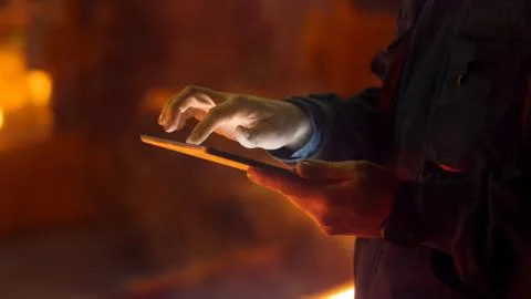 Engineer in Glasses using Tablet PC in Foundry. Industrial Environment. Stock Photos