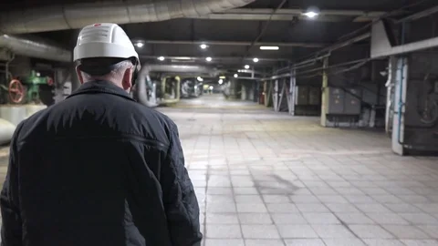 Engineer go on factory. Engineers in production hall Stock Footage 106966955