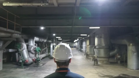 Engineer go on factory. Engineers in production hall Stock Footage 106966977