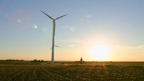 The engineer goes against the background of the windmills. Video stock 76589738