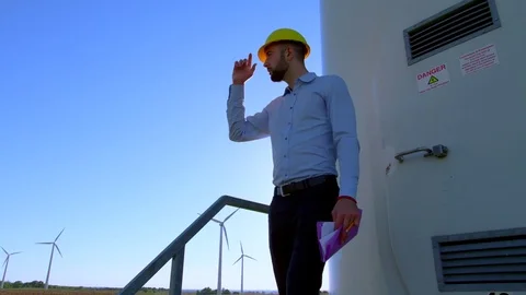 The engineer goes down the steps of the windmill. Stock-Footage 76620562