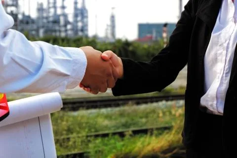 The engineer guy is shaking hands with construction manager. Stock Photos