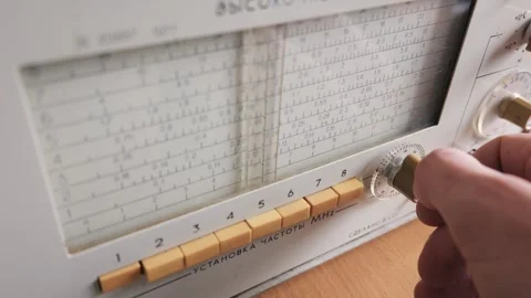 Engineer Hand Adjusting Dial on Vintage Analog Frequency Signal Generator Stock Footage 333820336