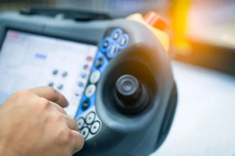 Engineer hand point at control button of robot to control in the factory. Use 写真素材