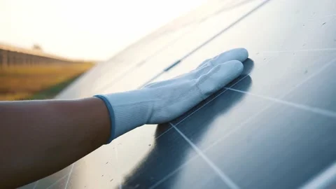 Engineer hand touching and sliding on photovoltaic solar battery cell to check Stock Footage 138890474