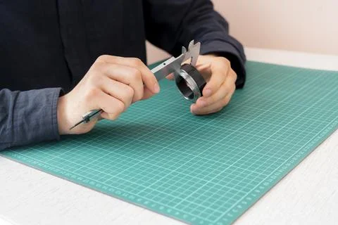 The engineer hand working and measure the parts with caliper tool Stock Photos