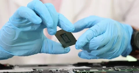 Engineer hands closeup of computer technician in gloves holding CPU processor Stock Footage 257062173