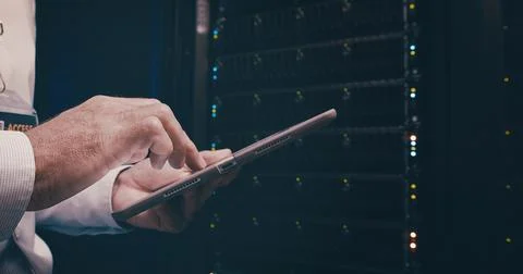 Engineer, hands or man with tablet in server room for security audit, system Foto stock